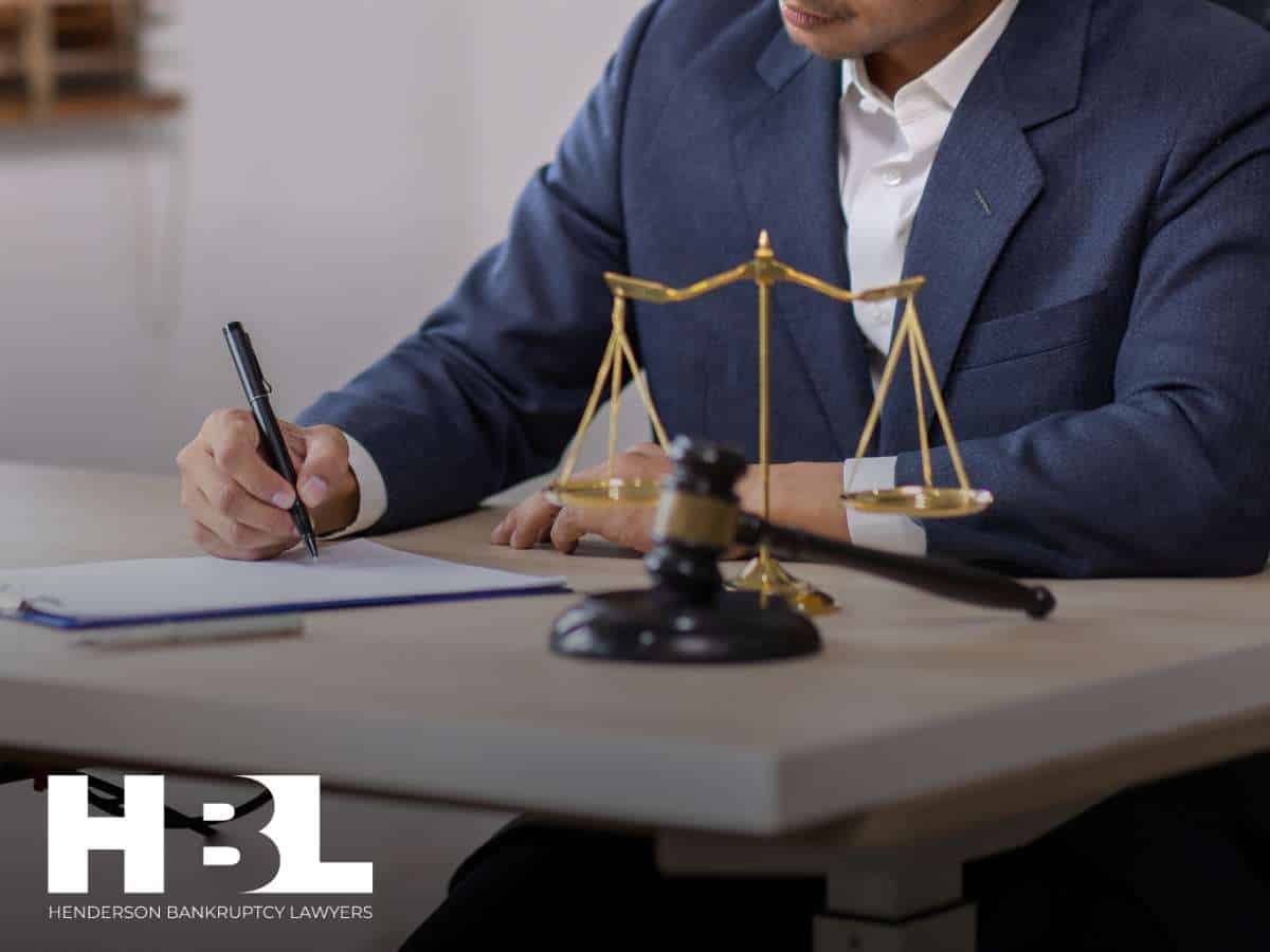 Attorney reviewing bankruptcy documents with scales of justice