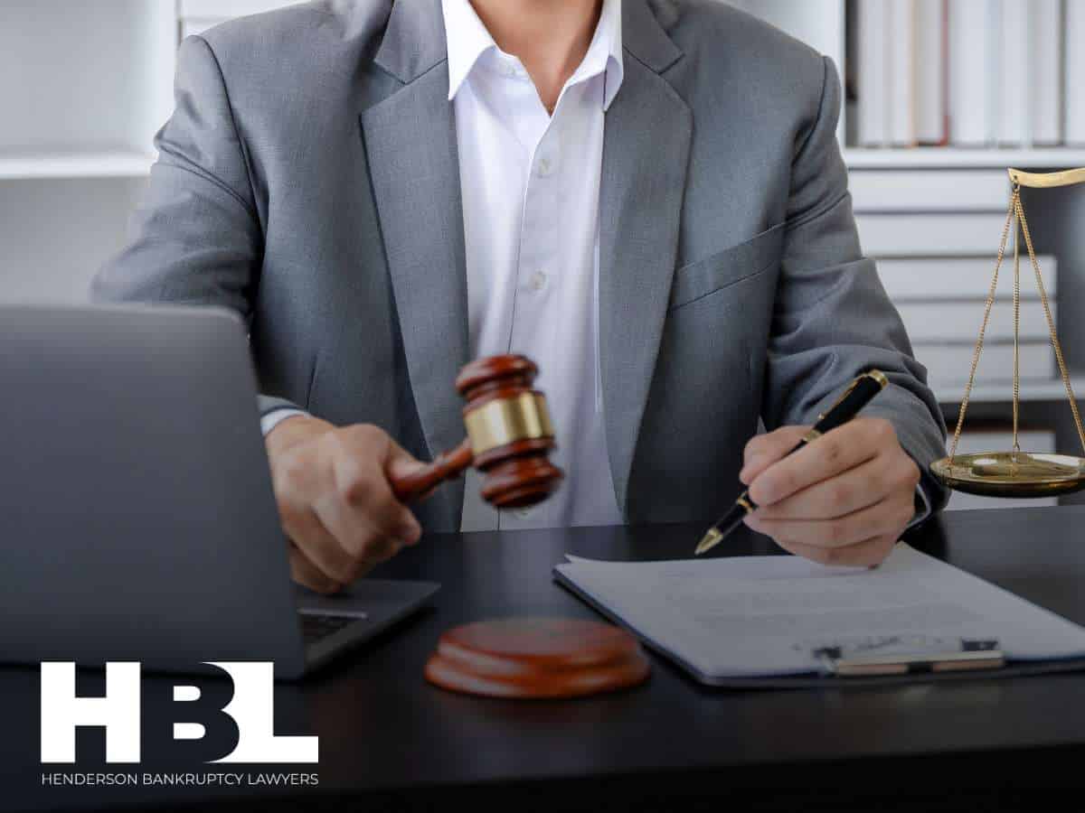 Lawyer reviewing documents with gavel in hand | bankruptcy case discussion